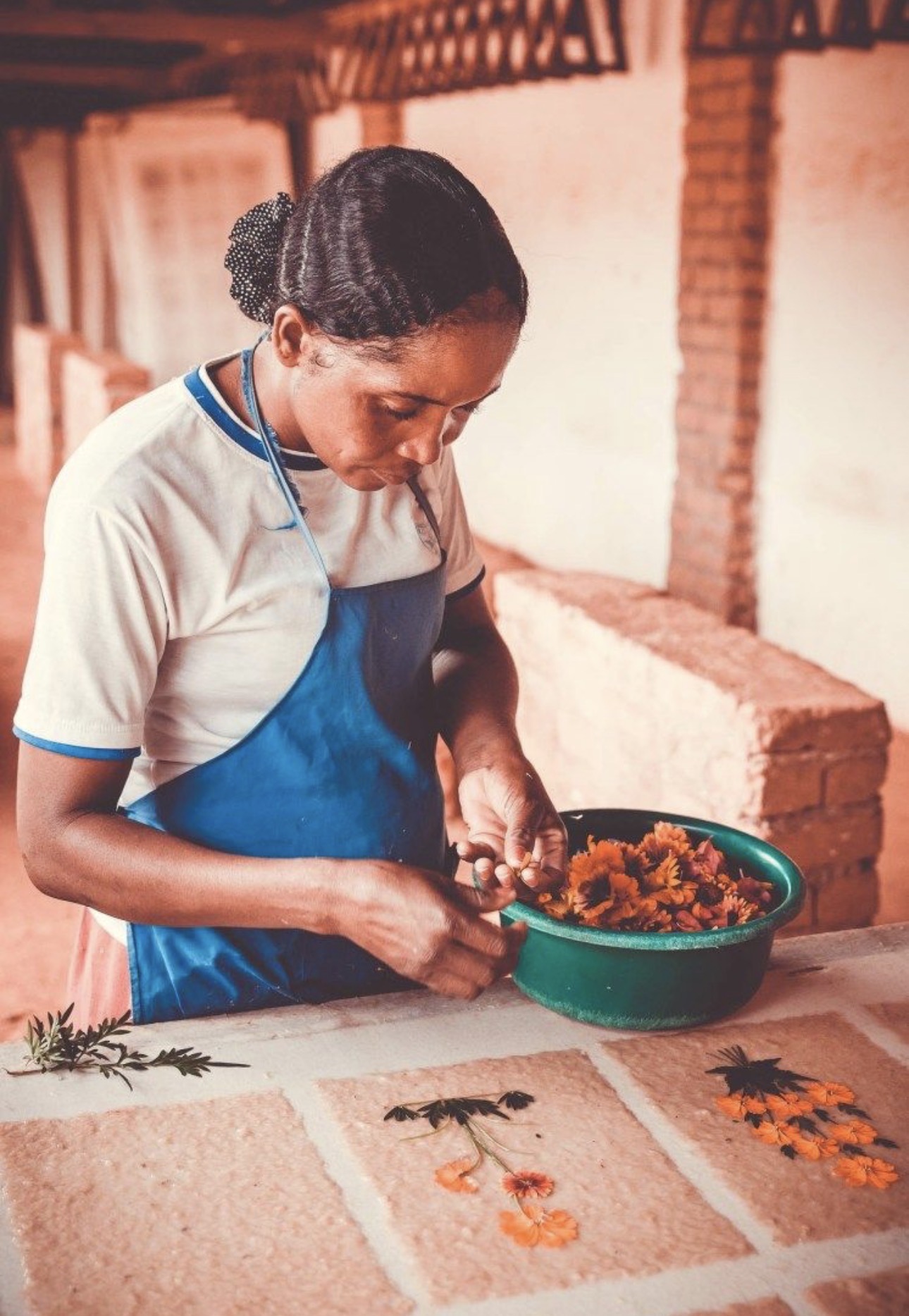 A woman preparing handmade paper and flowers